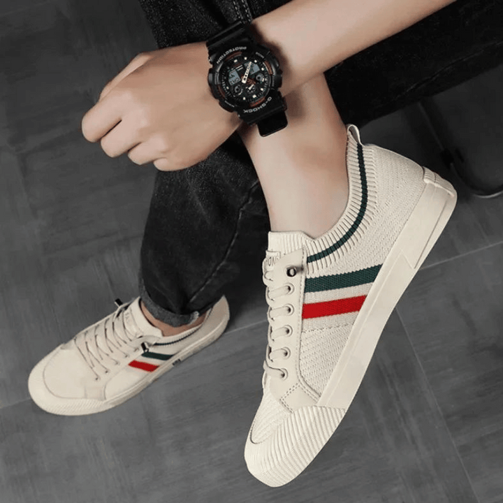 "Men’s casual sneakers in breathable knit fabric, lace-up design with durable rubber sole, perfect for everyday comfort."