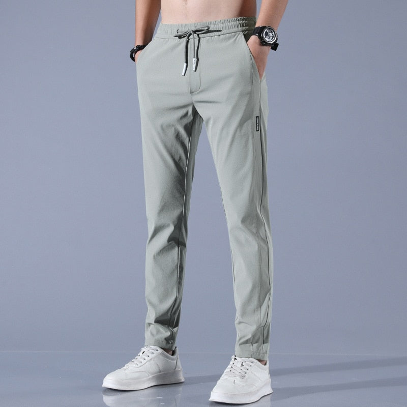Men's cotton chino pants with a sleek, modern fit in versatile shades, perfect for formal or casual occasions.