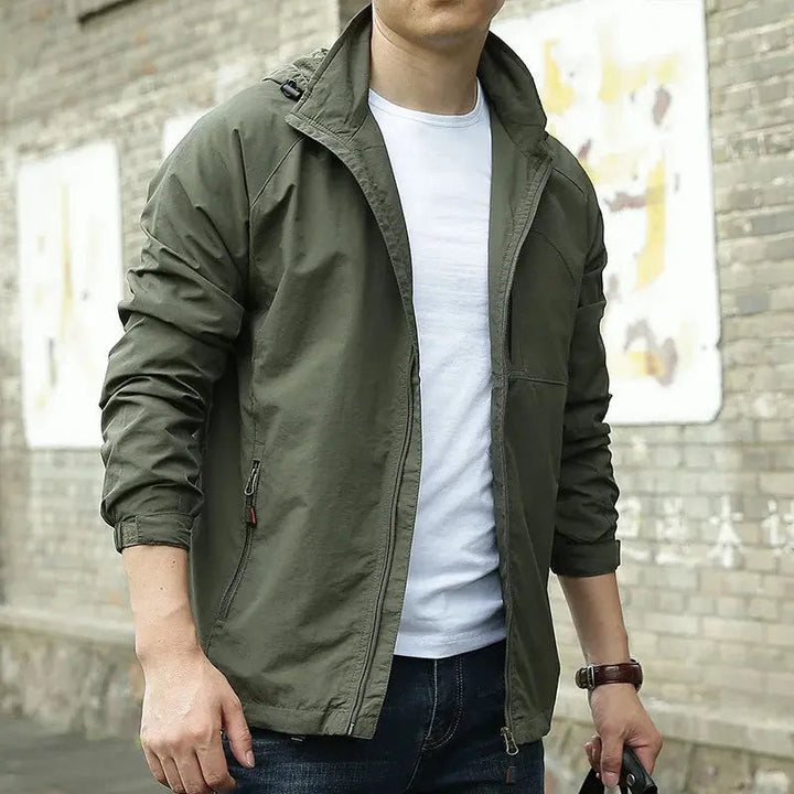 Men's lightweight breathable all-season jacket, sleek design, dark color, highlighting its comfort and versatility for layeri