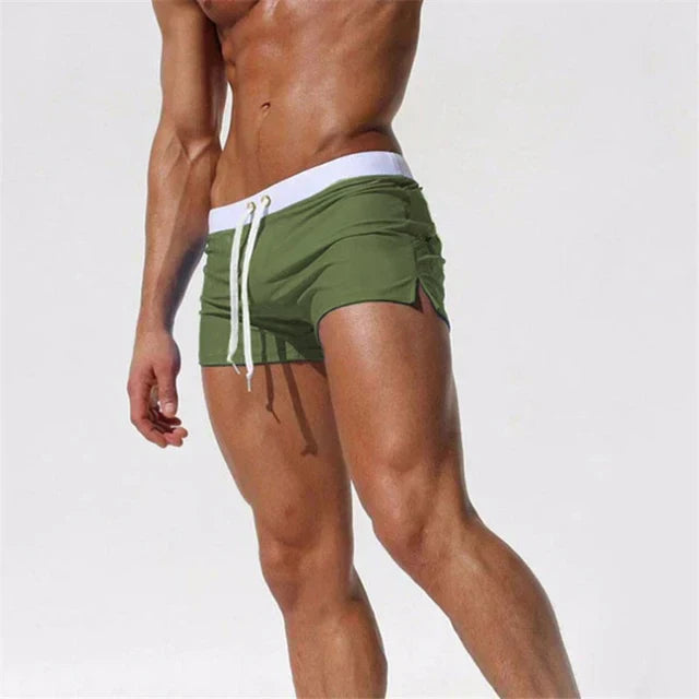 "Men's quick-dry swim shorts with adjustable waistband, sleek design, side slits, and drawstring closure for swim comfort."