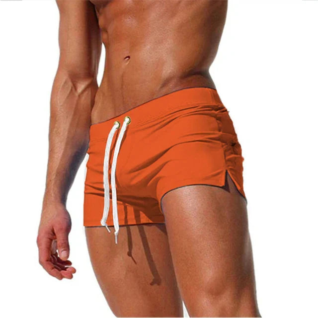 "Men's quick-dry swim shorts with adjustable waistband, sleek design, side slits, and drawstring closure for swim comfort."