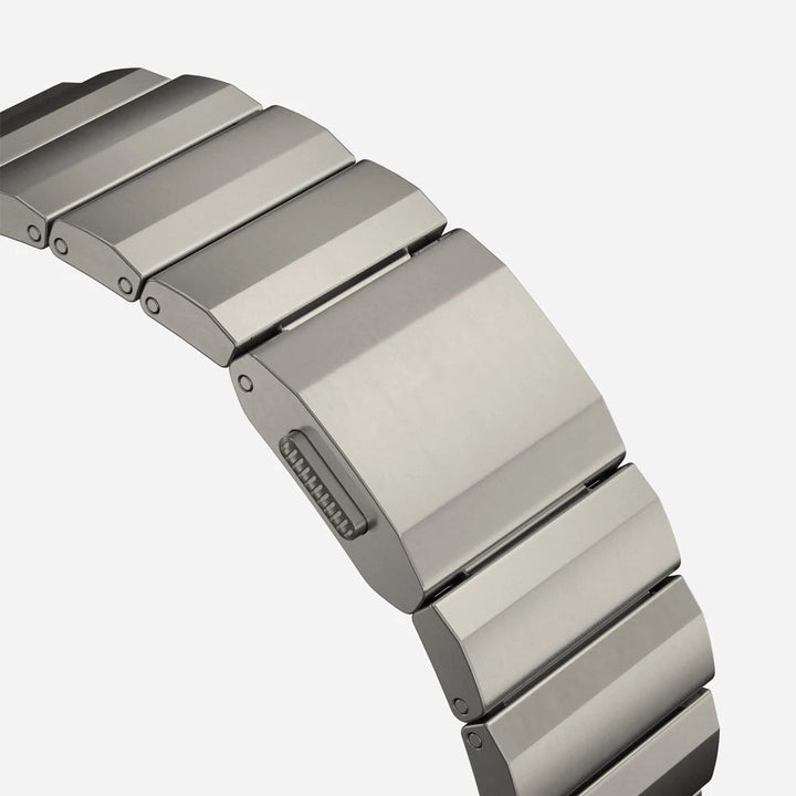 Men's sleek titanium watch band with shiny finish, magnetic clasp, durable and lightweight; perfect for daily or formal wear.