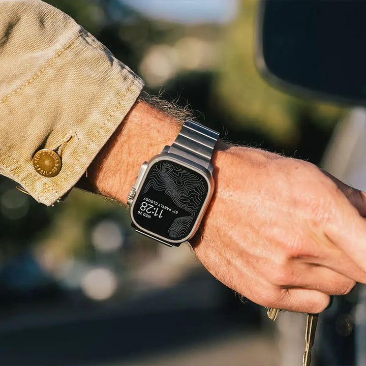 Men's sleek titanium watch band with shiny finish, magnetic clasp, durable and lightweight; perfect for daily or formal wear.