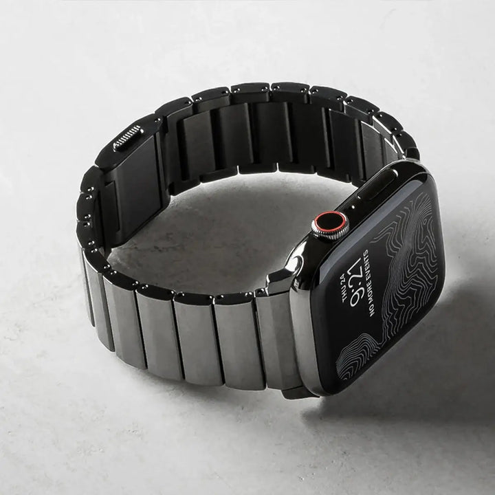 Men's sleek titanium watch band with shiny finish, magnetic clasp, durable and lightweight; perfect for daily or formal wear.
