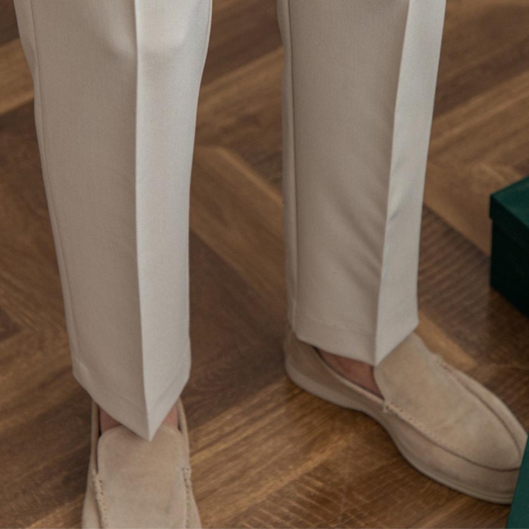Men’s tailored essential trousers in classic colors, streamlined fit, perfect for formal or casual wear, showcasing elegance.
