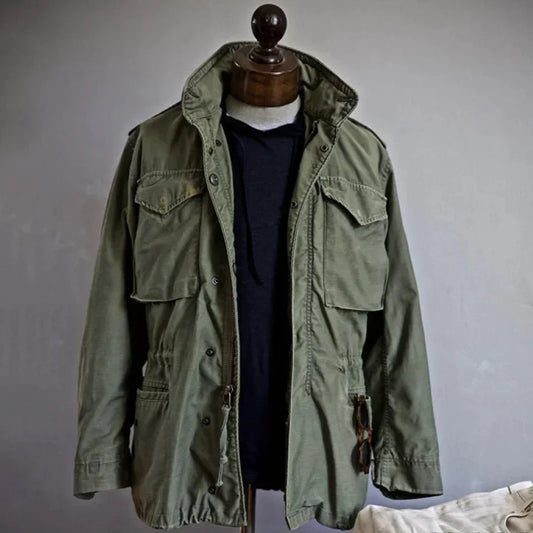 Men's vintage cotton field jacket with adjustable waist, rugged design, breathable fabric, suitable for layering.
