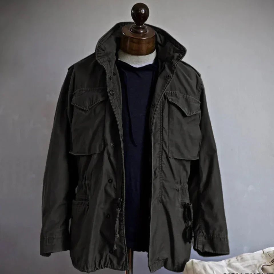 Men's vintage cotton field jacket with adjustable waist, rugged design, breathable fabric, suitable for layering.