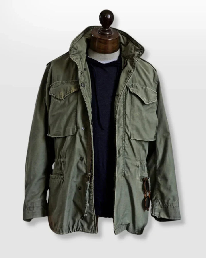 Men's vintage cotton field jacket with adjustable waist, rugged design, breathable fabric, suitable for layering.