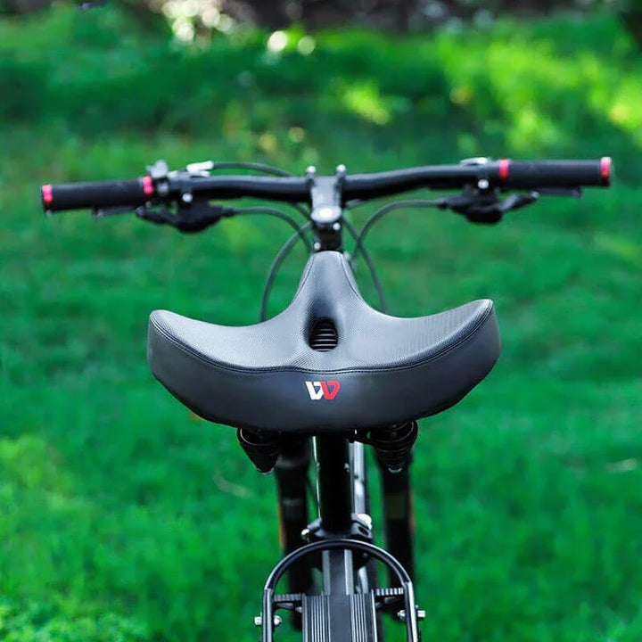 Men's wide bicycle saddle with shock absorption, ergonomic design, and ventilation in durable, water-resistant PU leather.