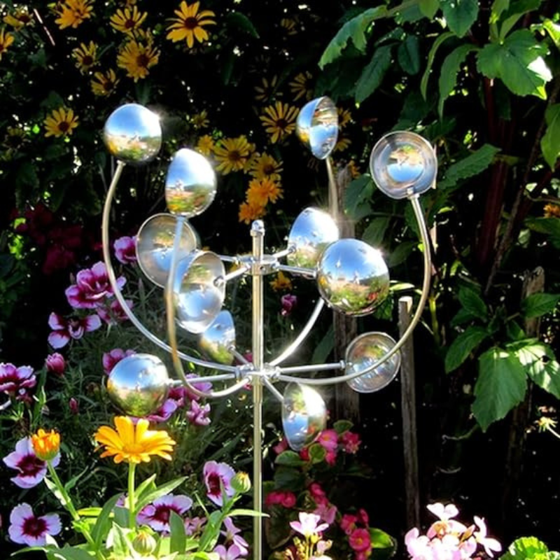"Metallic wind spinner sculpture for garden decor, tall iron structure with dazzling finish, spins in the slightest breeze."