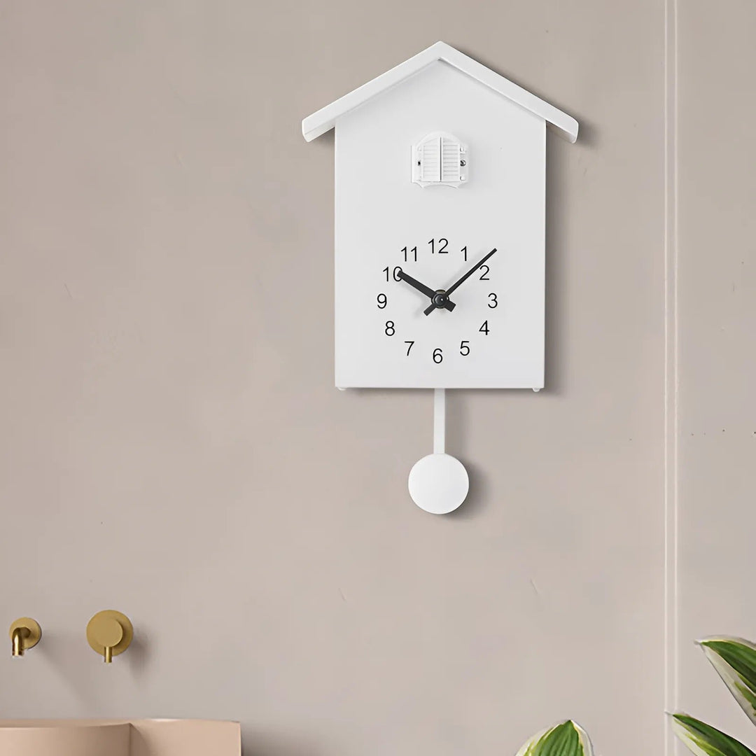 "Minimalist cuckoo wall clock with sleek black and white finish, modern design, whimsical bird element, compact 20x25cm size.