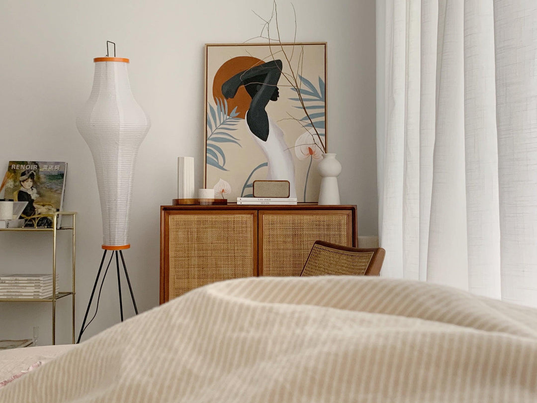 "Minimalist rice paper floor lamp with sleek metal frame and soft diffused light, perfect for creating a warm ambiance."
