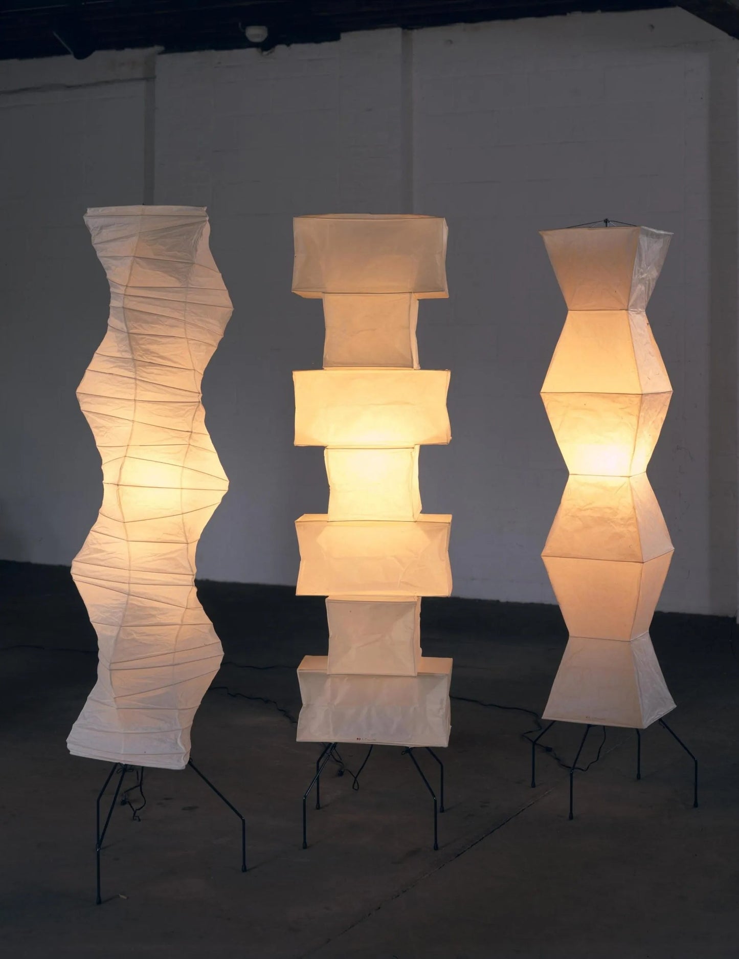 "Minimalist rice paper floor lamp with sleek metal frame and soft diffused light, perfect for creating a warm ambiance."