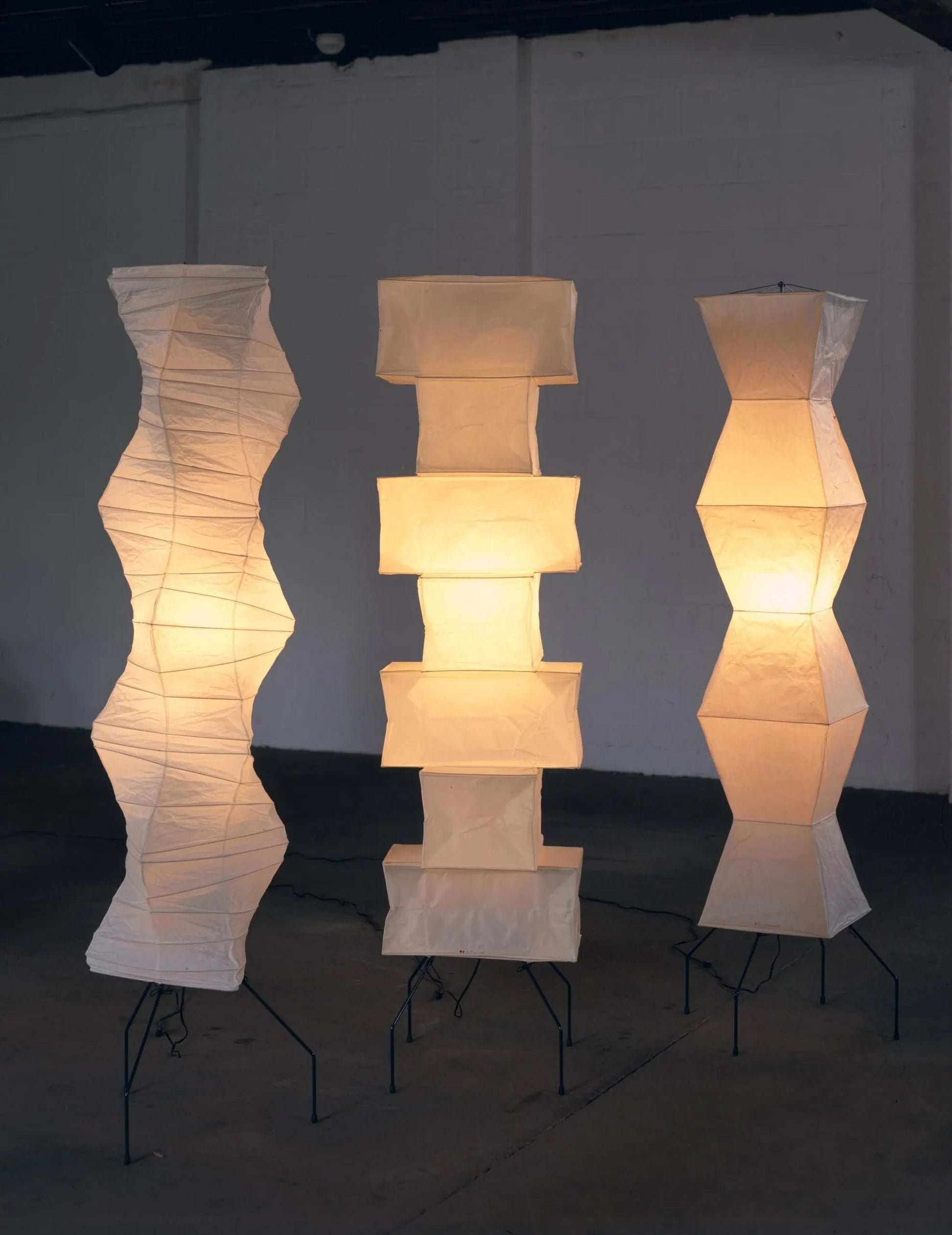 "Minimalist rice paper floor lamp with sleek metal frame and soft diffused light, perfect for creating a warm ambiance."