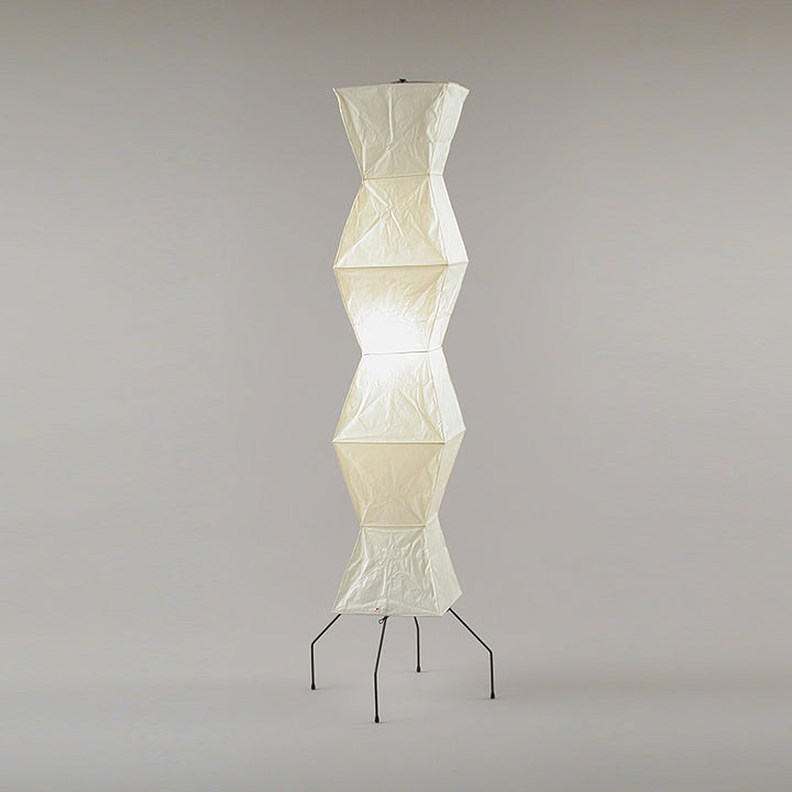 "Minimalist rice paper floor lamp with sleek metal frame and soft diffused light, perfect for creating a warm ambiance."