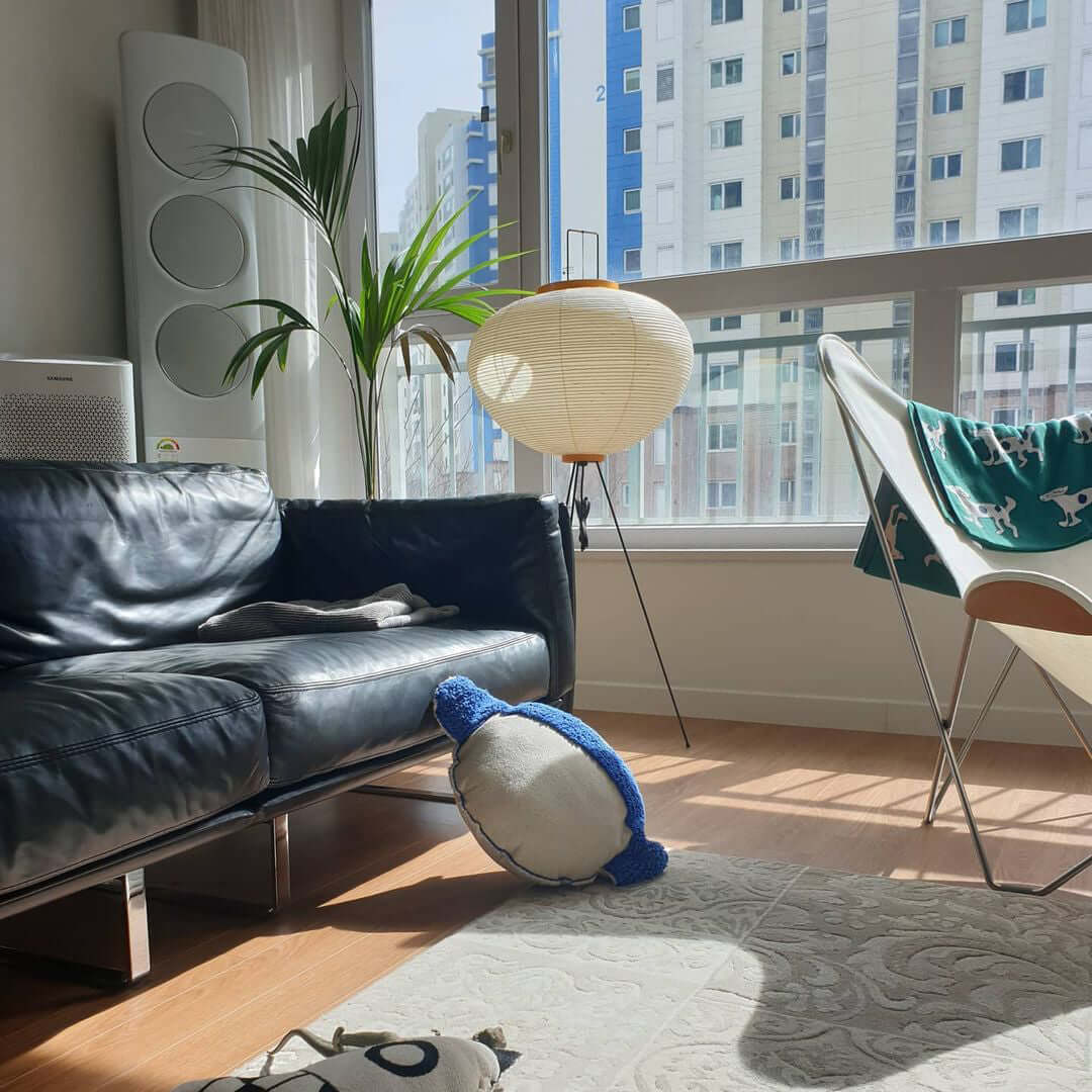 "Minimalist rice paper floor lamp with sleek metal frame and soft diffused light, perfect for creating a warm ambiance."