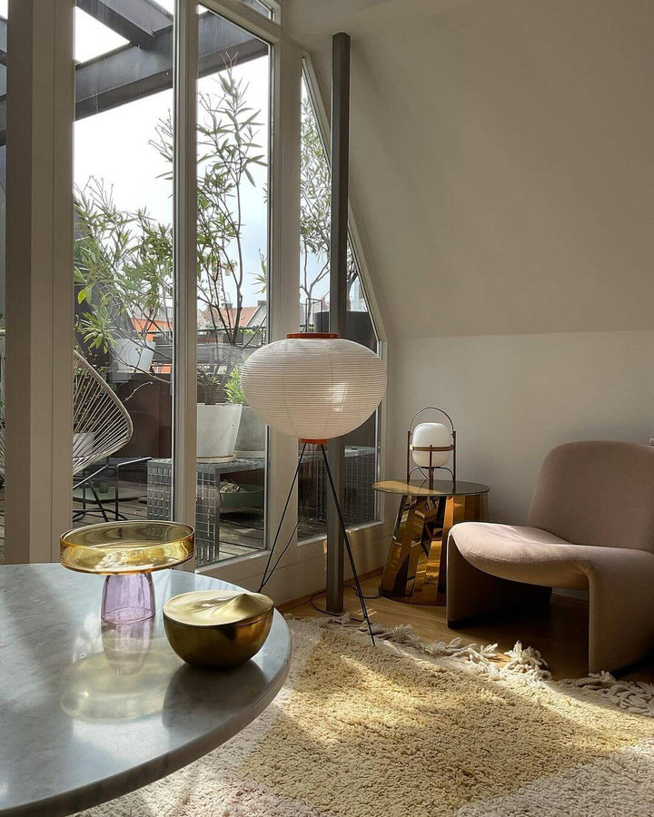 "Minimalist rice paper floor lamp with sleek metal frame and soft diffused light, perfect for creating a warm ambiance."