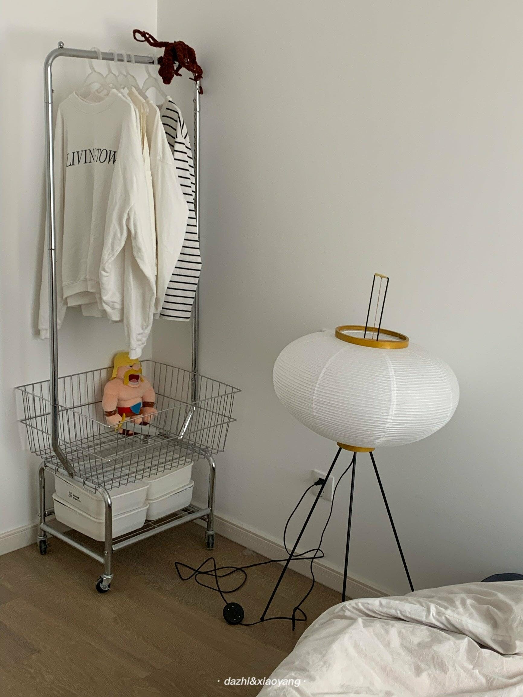 "Minimalist rice paper floor lamp with sleek metal frame and soft diffused light, perfect for creating a warm ambiance."