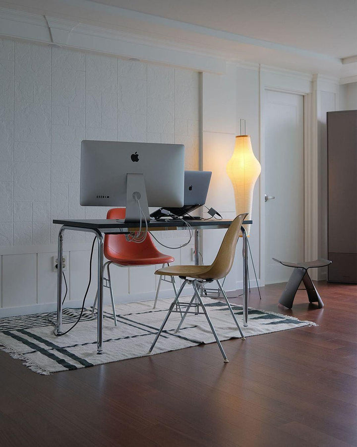 "Minimalist rice paper floor lamp with sleek metal frame and soft diffused light, perfect for creating a warm ambiance."