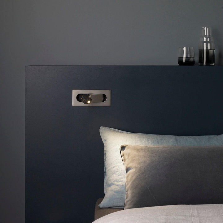 Modern adjustable LED bedside lamp in matte black with a sleek design, featuring an adjustable head for focused reading light
