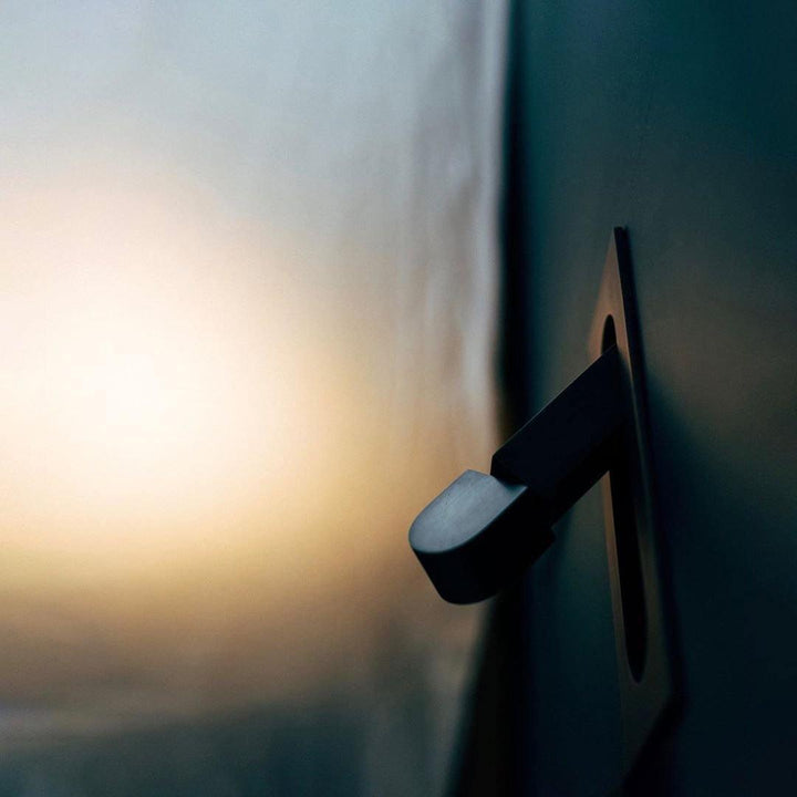Modern adjustable LED bedside lamp in matte black with a sleek design, featuring an adjustable head for focused reading light