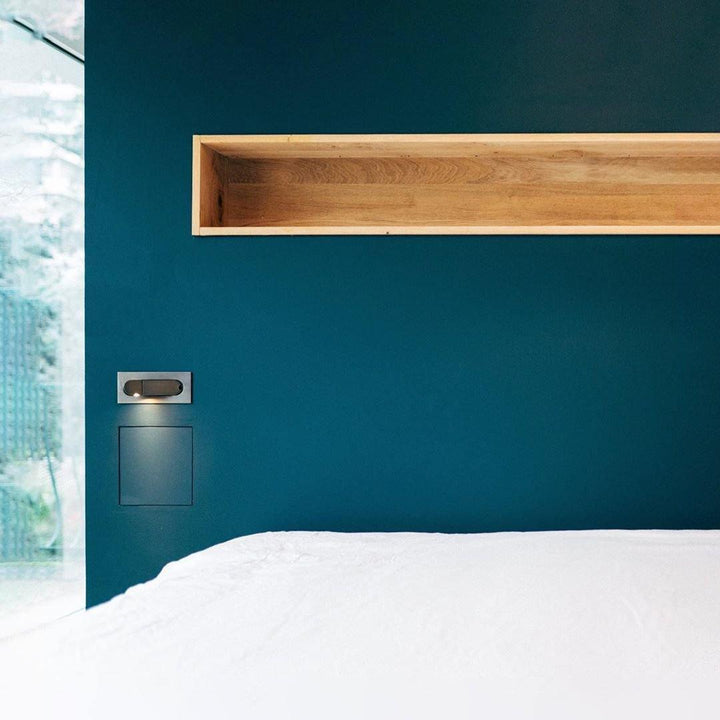 Modern adjustable LED bedside lamp in matte black with a sleek design, featuring an adjustable head for focused reading light