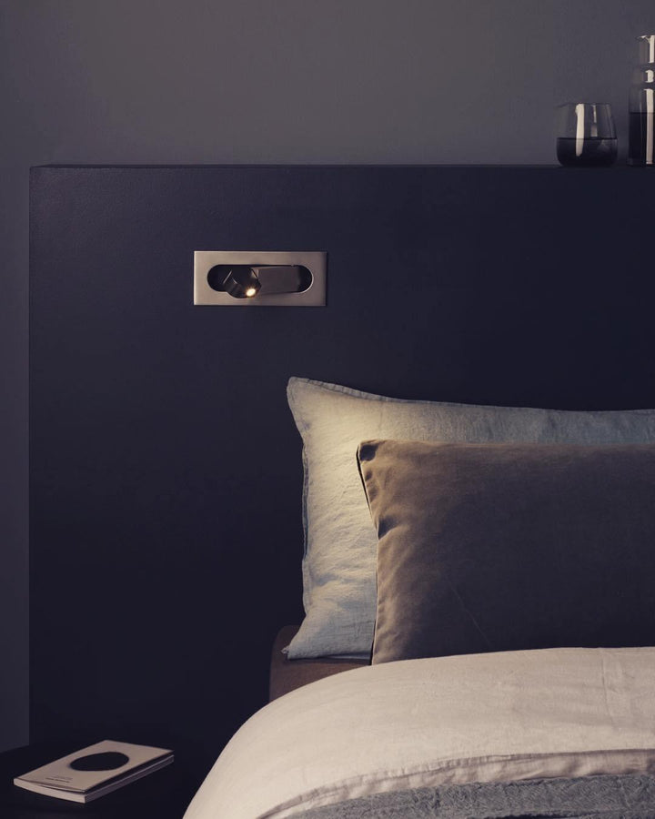 Modern adjustable LED bedside lamp in matte black with a sleek design, featuring an adjustable head for focused reading light