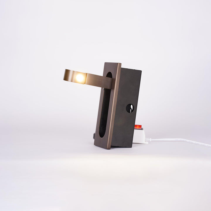 Modern adjustable LED bedside lamp in matte black with a sleek design, featuring an adjustable head for focused reading light