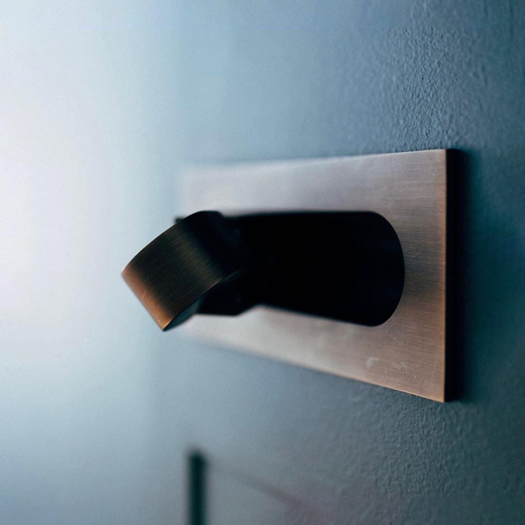 Modern adjustable LED bedside lamp in matte black with a sleek design, featuring an adjustable head for focused reading light