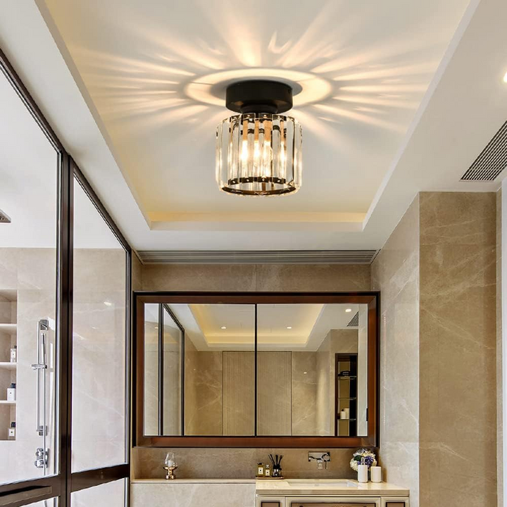 Modern black crystal flush mount ceiling light, sleek brass fixture, crystal shade, ideal for rooms with low ceilings.