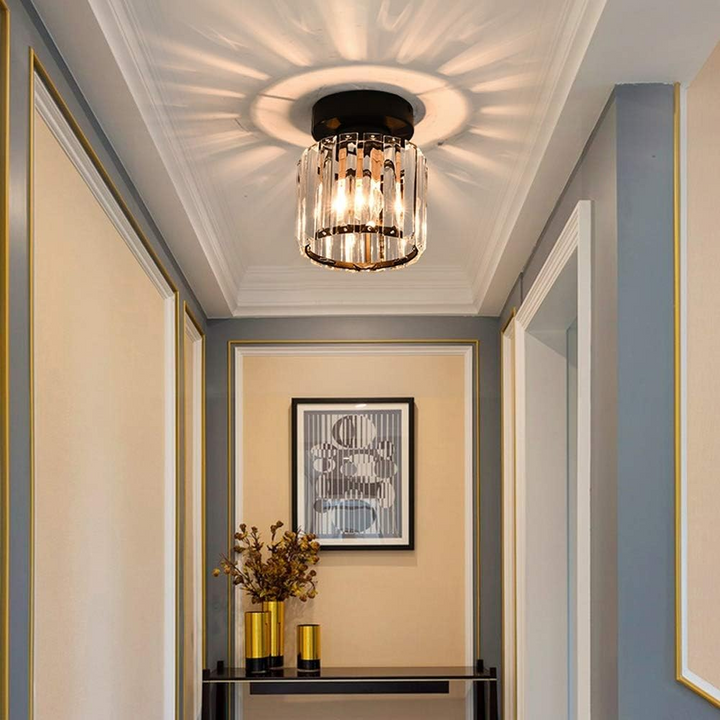 Modern black crystal flush mount ceiling light, sleek brass fixture, crystal shade, ideal for rooms with low ceilings.