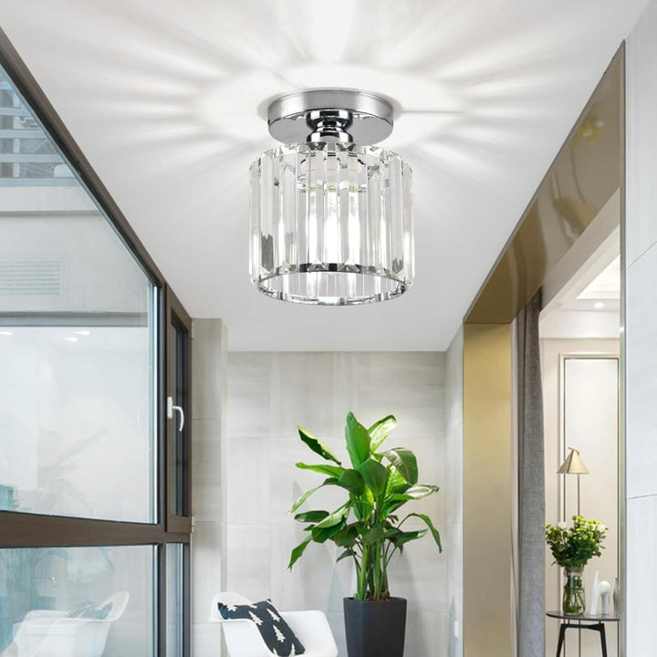 Modern black crystal flush mount ceiling light, sleek brass fixture, crystal shade, ideal for rooms with low ceilings.