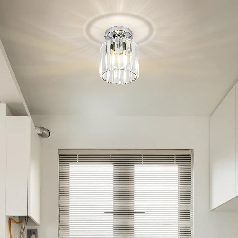 Modern black crystal flush mount ceiling light, sleek brass fixture, crystal shade, ideal for rooms with low ceilings.