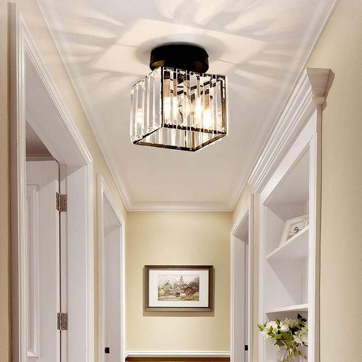 Modern black crystal flush mount ceiling light, sleek brass fixture, crystal shade, ideal for rooms with low ceilings.