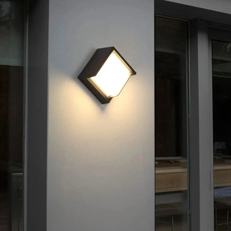 Modern black LED outdoor wall light with motion sensor, waterproof ABS, enhances security, suits balconies, porches, gardens.