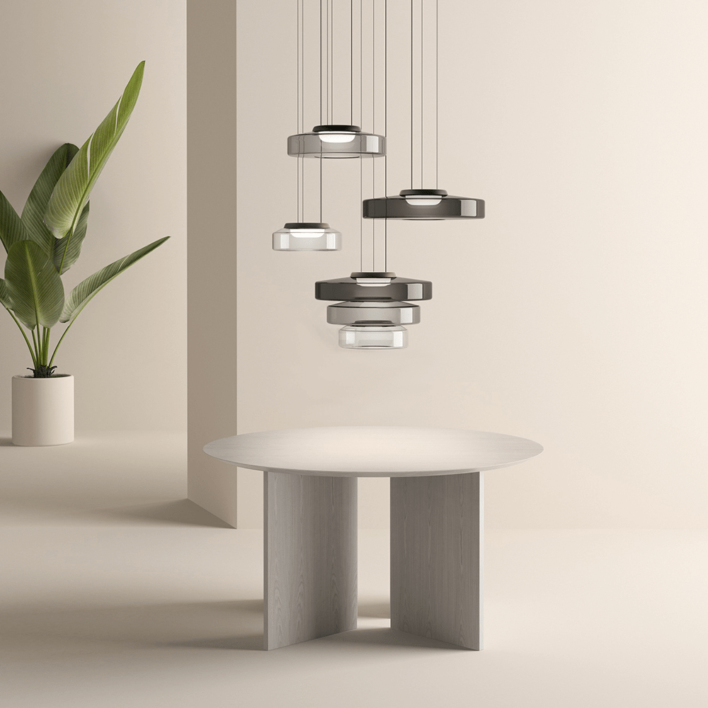 "Modern glass pendant lamp in Bauhaus design, smoke grey shade, adjustable cable, warm LED glow, ideal for home interiors."