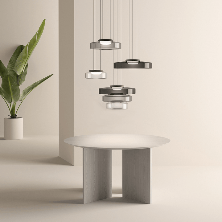 "Modern glass pendant lamp in Bauhaus design, smoke grey shade, adjustable cable, warm LED glow, ideal for home interiors."