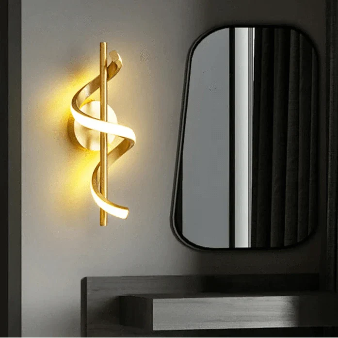 Modern LED wall sconce with adjustable gold arm and copper finish, ideal for ambient lighting in living rooms and bedrooms.