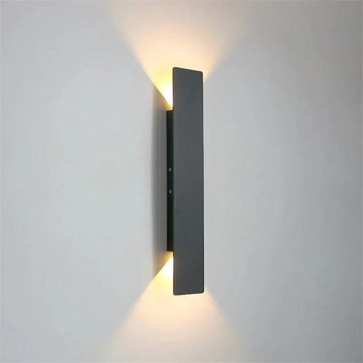 Modern outdoor LED wall light, black or white finish, IP65 waterproof, up/down lighting, enhances exterior decor.