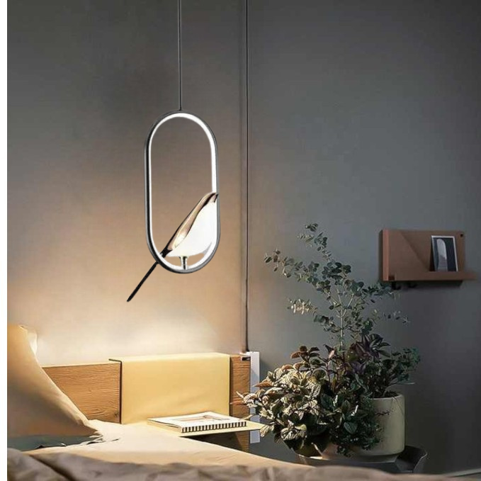 "Modern pendant light with elegant golden bird design in a minimalist frame, ideal for serene home environments."