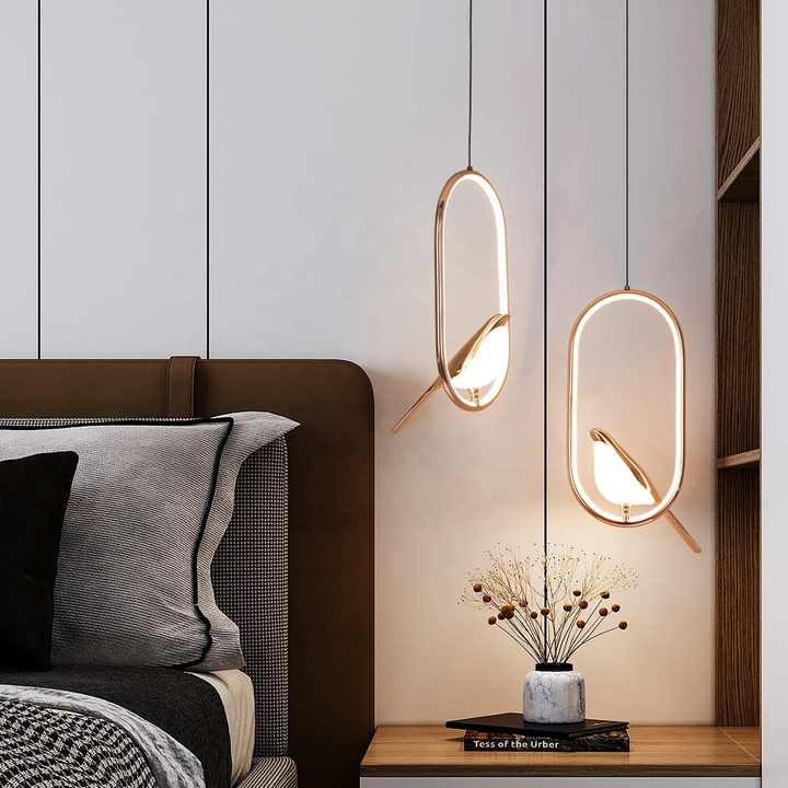 "Modern pendant light with elegant golden bird design in a minimalist frame, ideal for serene home environments."