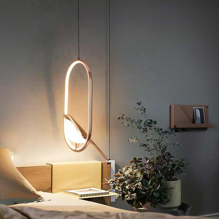 "Modern pendant light with elegant golden bird design in a minimalist frame, ideal for serene home environments."
