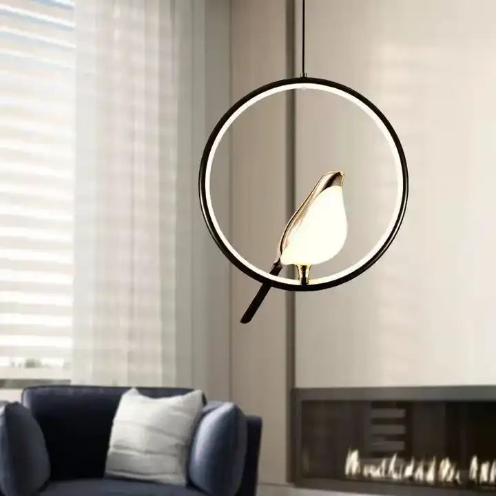 "Modern pendant light with elegant golden bird design in a minimalist frame, ideal for serene home environments."