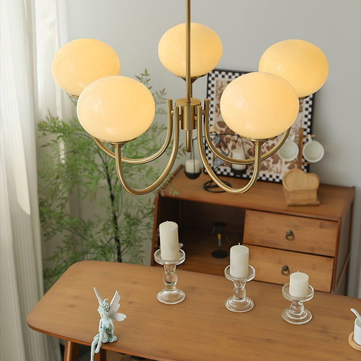 Modern pink and gold chandelier with elegant glass shades, ideal ceiling light fixture for chic home decor and illumination.