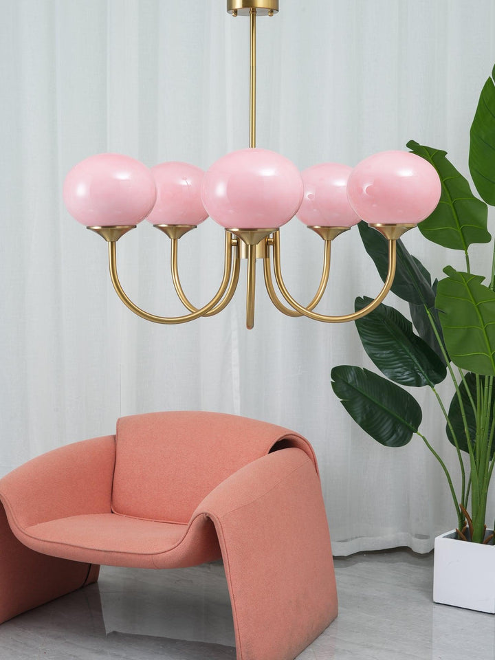 Modern pink and gold chandelier with elegant glass shades, ideal ceiling light fixture for chic home decor and illumination.