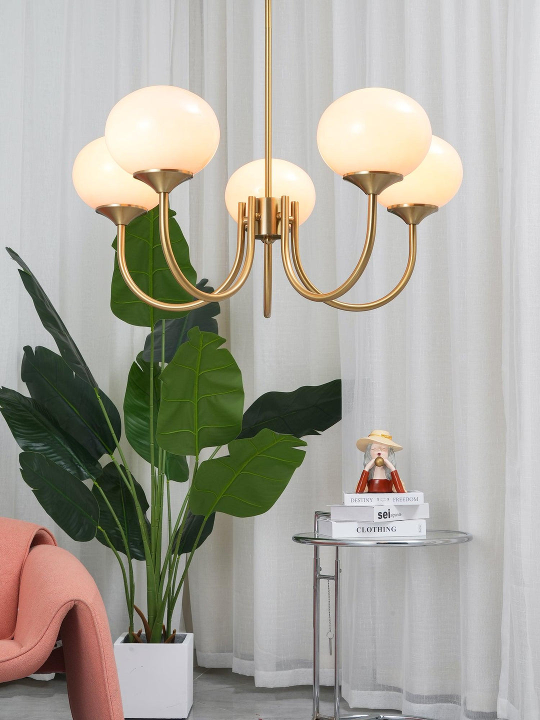 Modern pink and gold chandelier with elegant glass shades, ideal ceiling light fixture for chic home decor and illumination.
