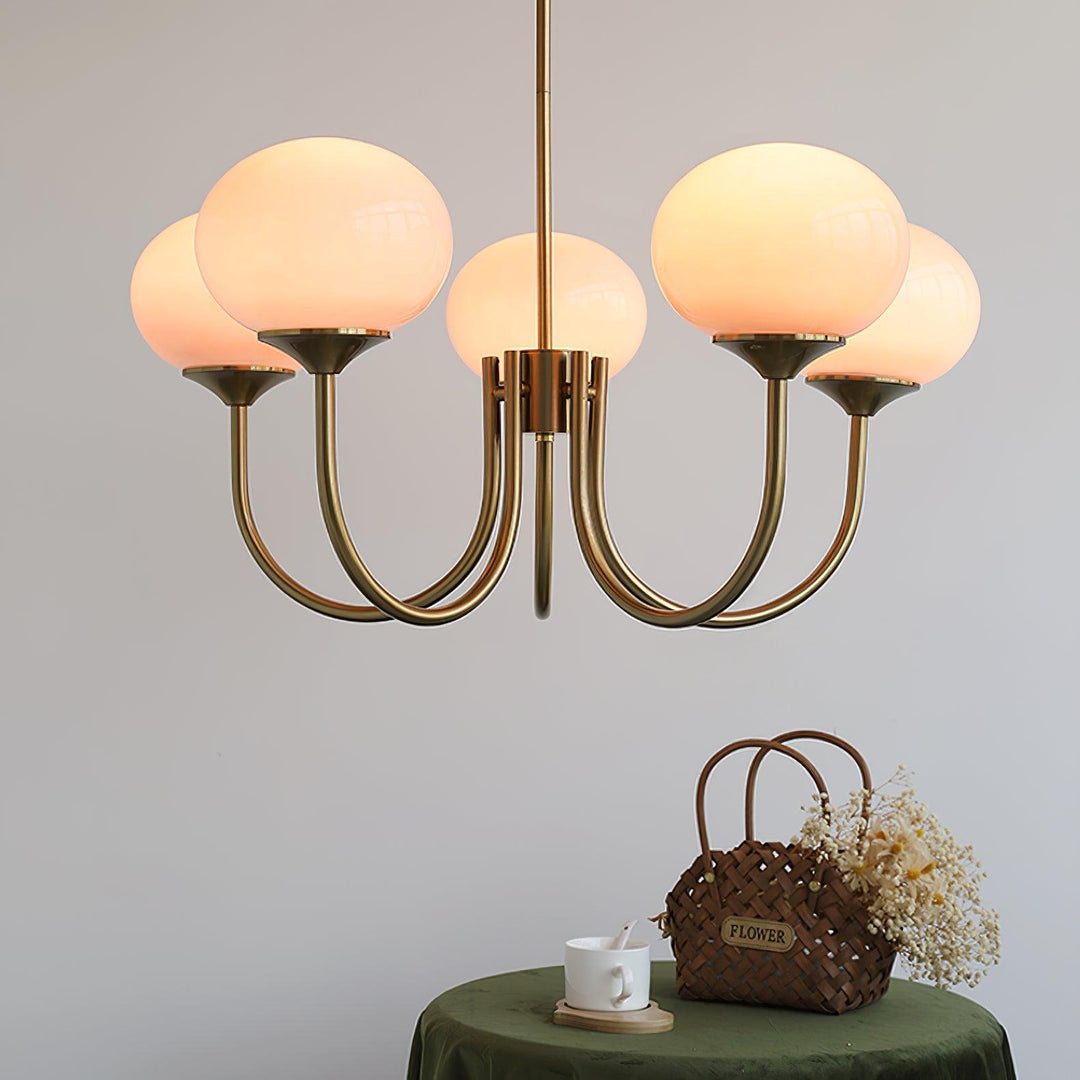 Modern pink and gold chandelier with elegant glass shades, ideal ceiling light fixture for chic home decor and illumination.