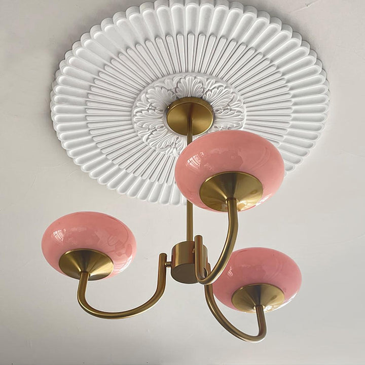 Modern pink and gold chandelier with elegant glass shades, ideal ceiling light fixture for chic home decor and illumination.