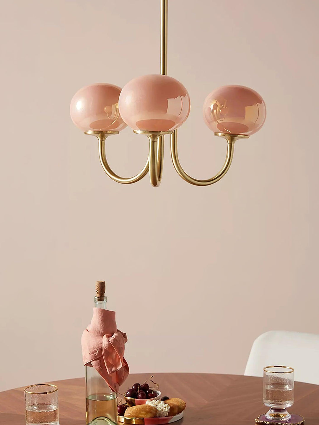 Modern pink and gold chandelier with elegant glass shades, ideal ceiling light fixture for chic home decor and illumination.