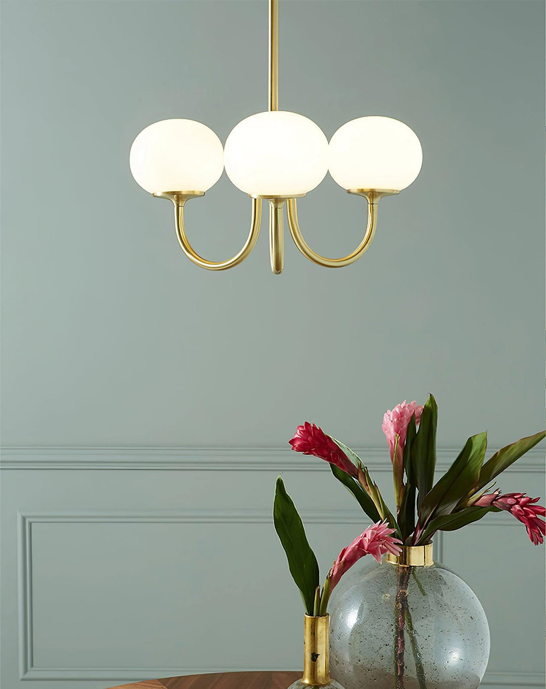 Modern pink and gold chandelier with elegant glass shades, ideal ceiling light fixture for chic home decor and illumination.